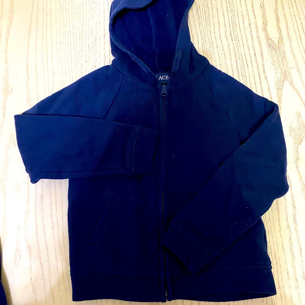 Two girl uniform sweaters